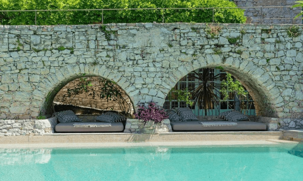 Shaded outdoor seating under trees in historic grounds